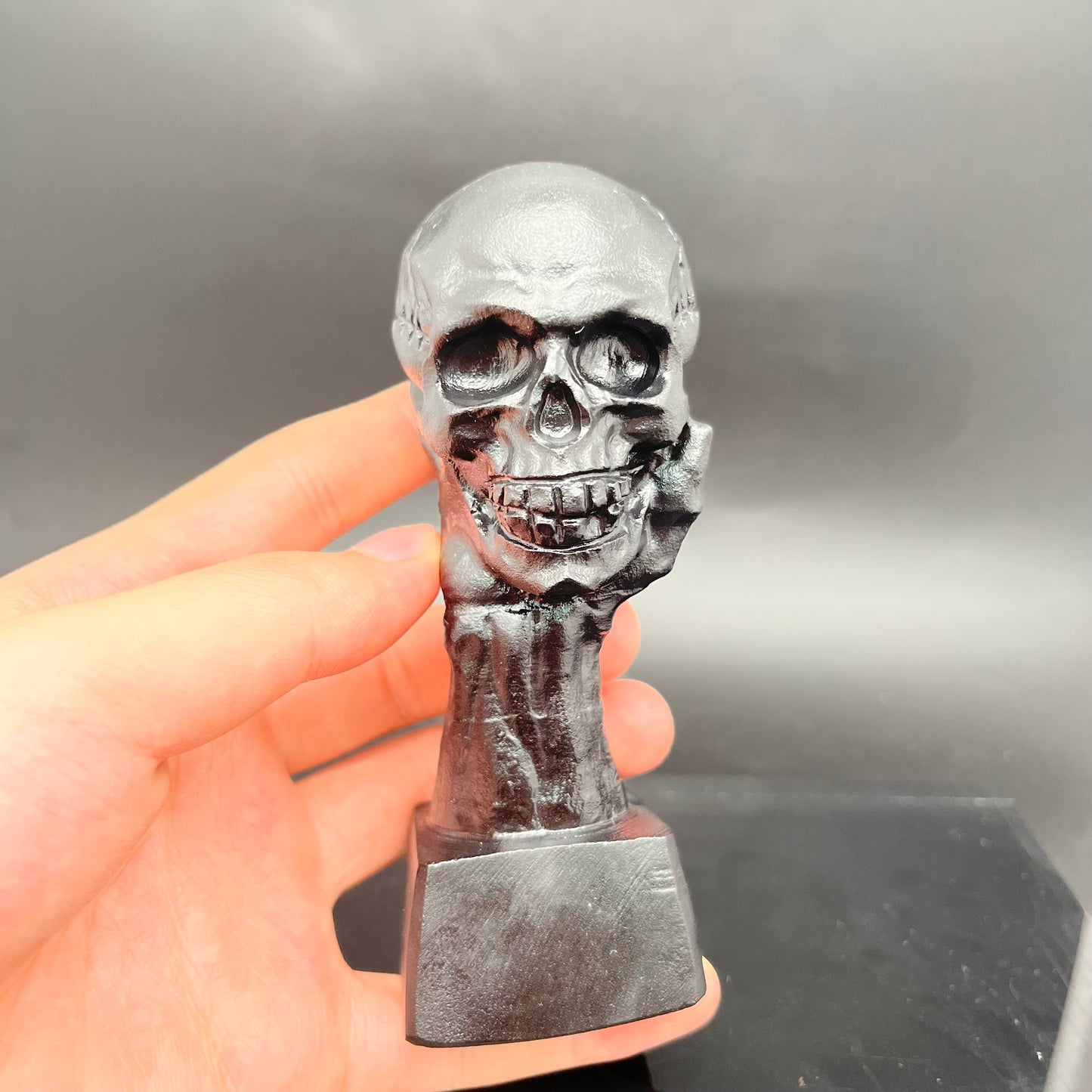 Black obsidian hand hold skull