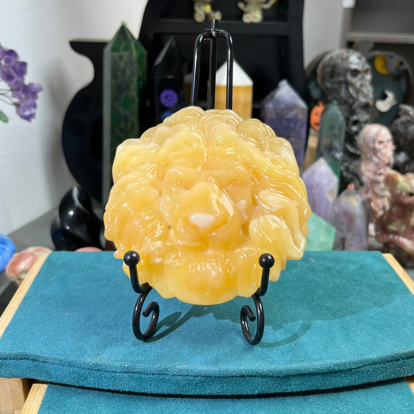 Orange calcite lion face carving