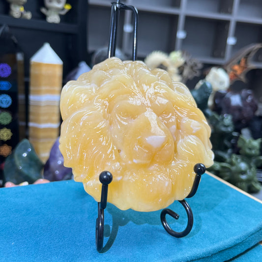 Orange calcite lion face carving