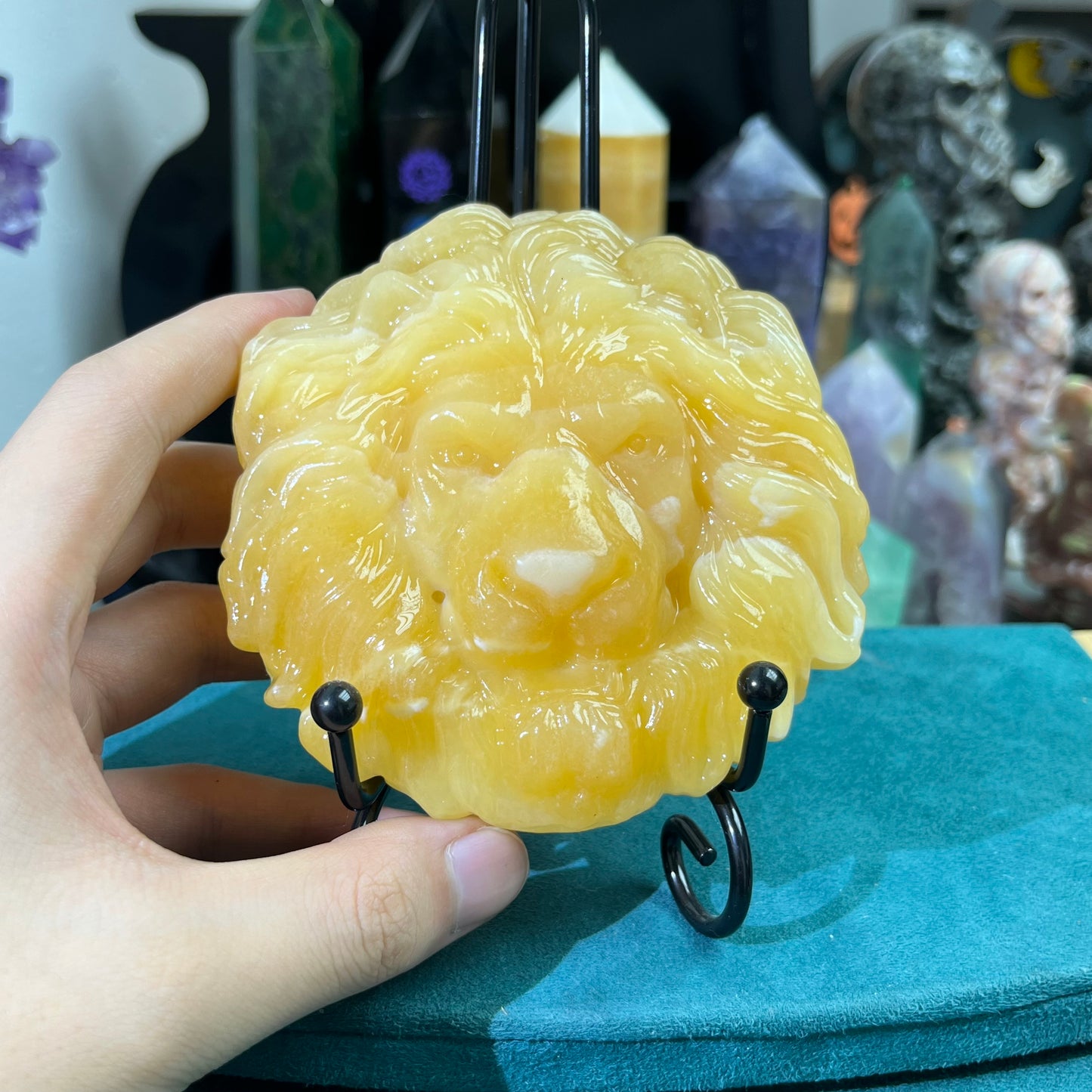 Orange calcite lion face carving