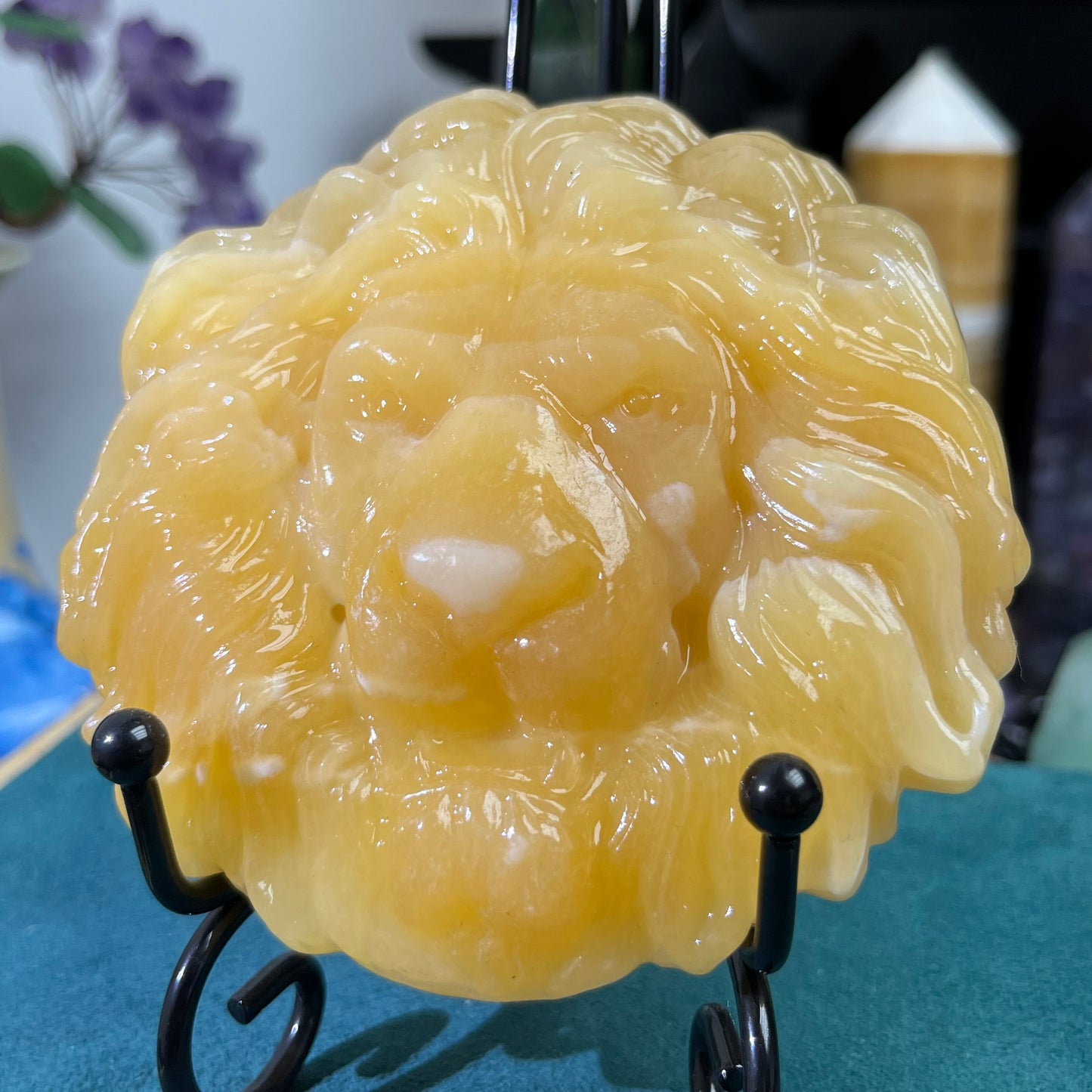 Orange calcite lion face carving